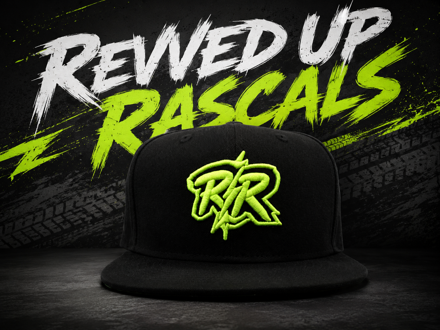 Black RR snapback cap with neon green Revved Up Rascals logo on a graffiti wall backdrop